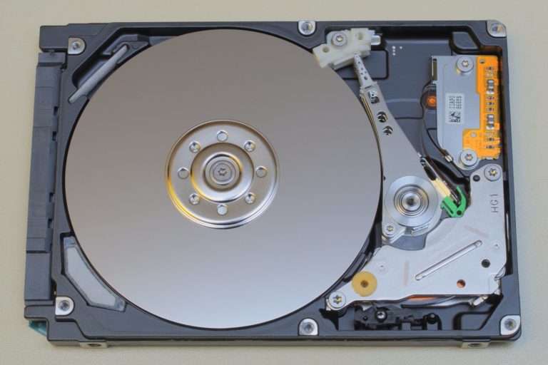 Disque dur d'ordinateur portable ouvert montrant le plateau et le bras de lecture