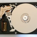 Intérieur d'un disque dur ouvert, plateau et bras de lecture visibles